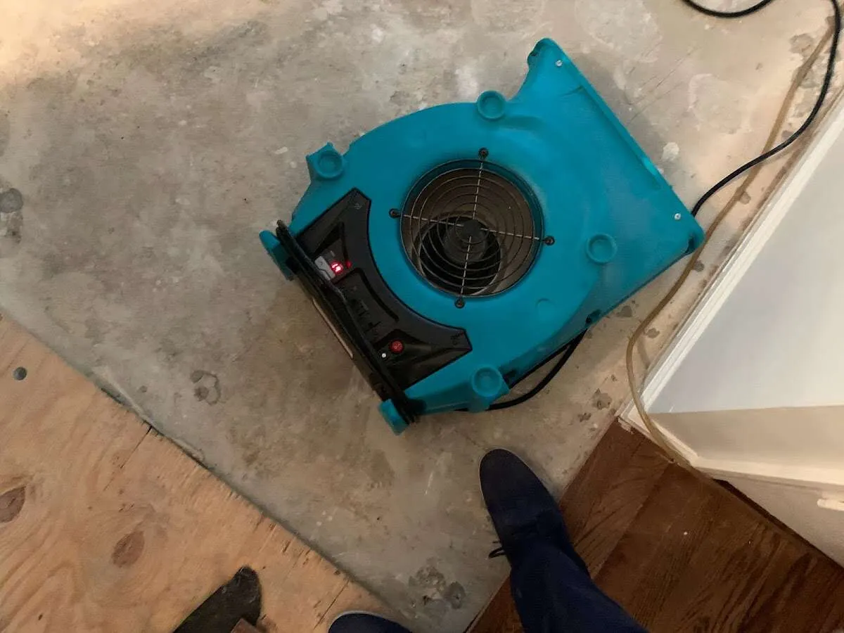 Air mover drying subfloor during Commercial Water Damage Restoration in Fort Lewis